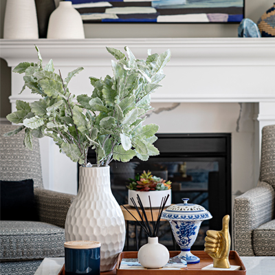 colourful living room decor with patterned chairs and fireplace Design by Aman Than Interiors and Photography by Mike Chajecki