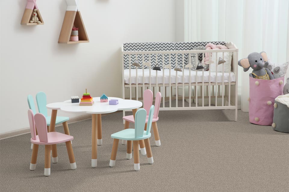 grey carpet in kid's bedroom with crib.